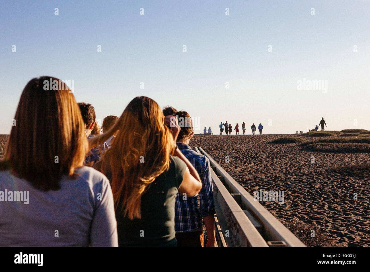 Back view of people walking in line Stock Photo