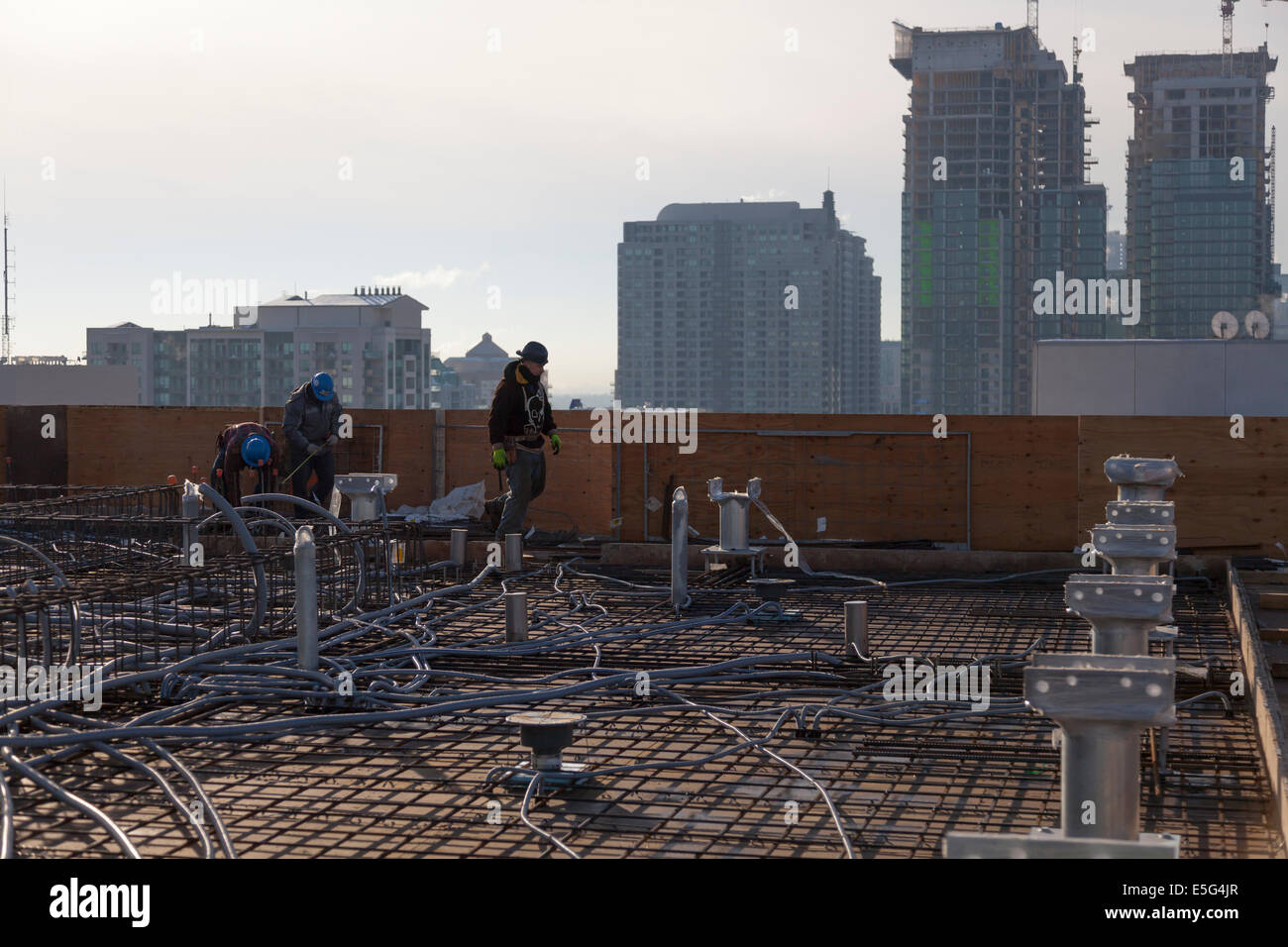 Construction workers on a rooftop construction site in Toronto, Ontario