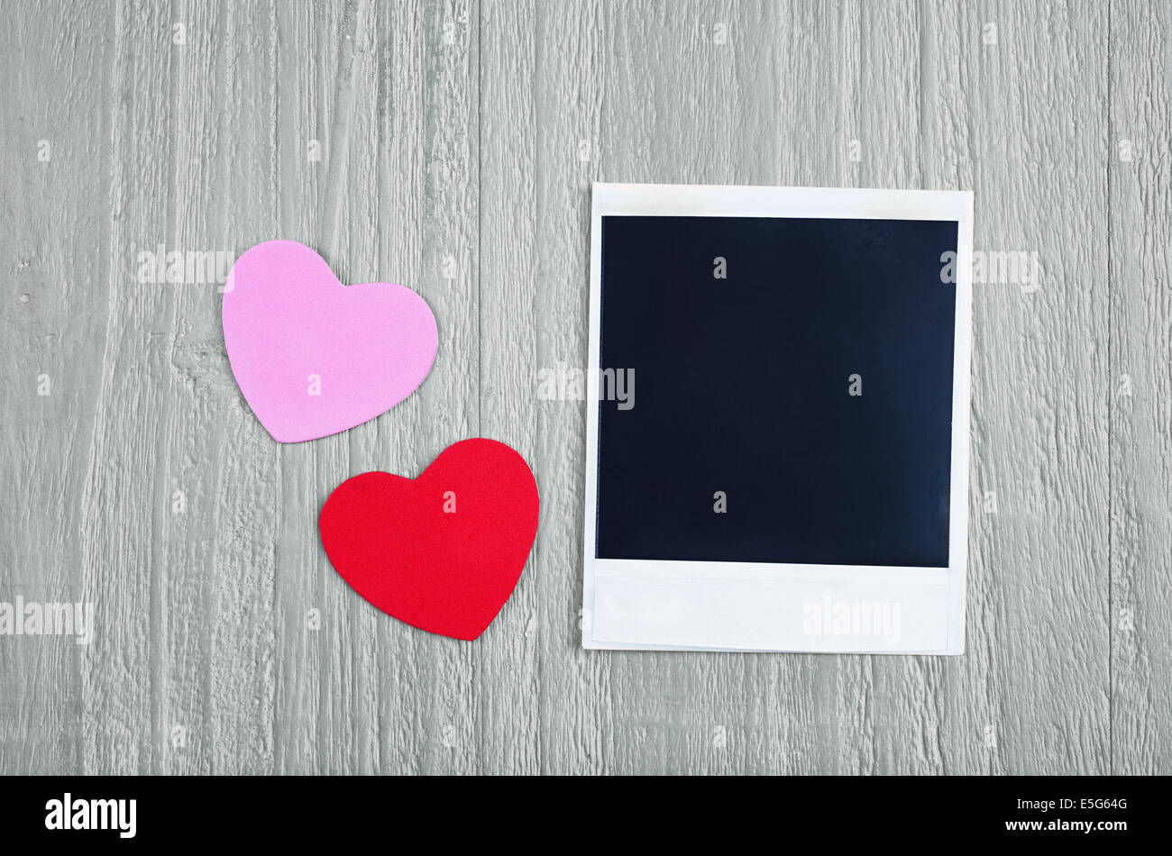 Valentines Day hearts and blank instant photo on vintage wooden background Stock Photo