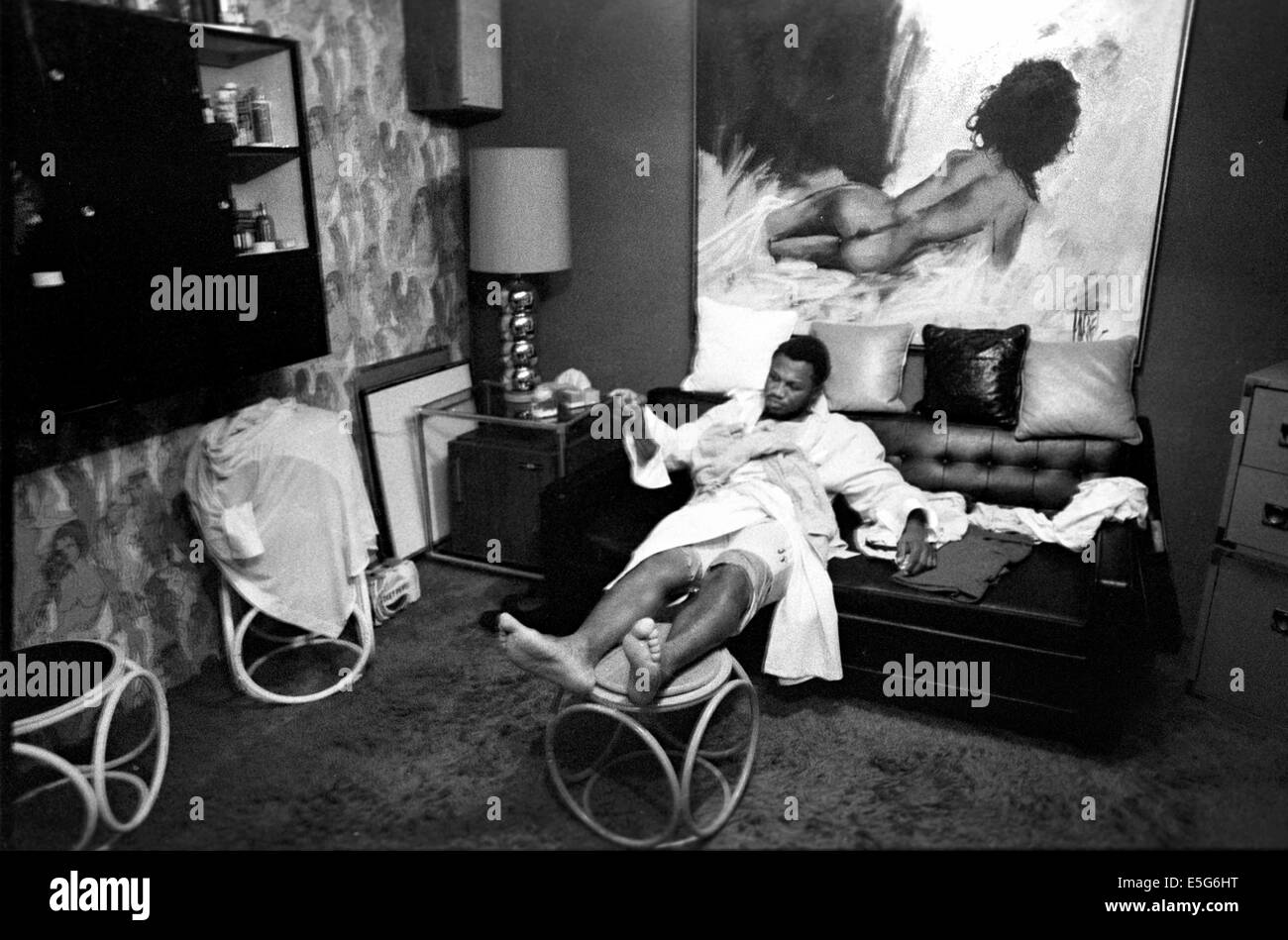 After a workout, heavyweight champion 'Smokin' Joe Frazier rests in his dressing room/office at his gym in north Philadelphia in 1975. Died in 2011 Professioal boxer from 1965-1981 Stock Photo