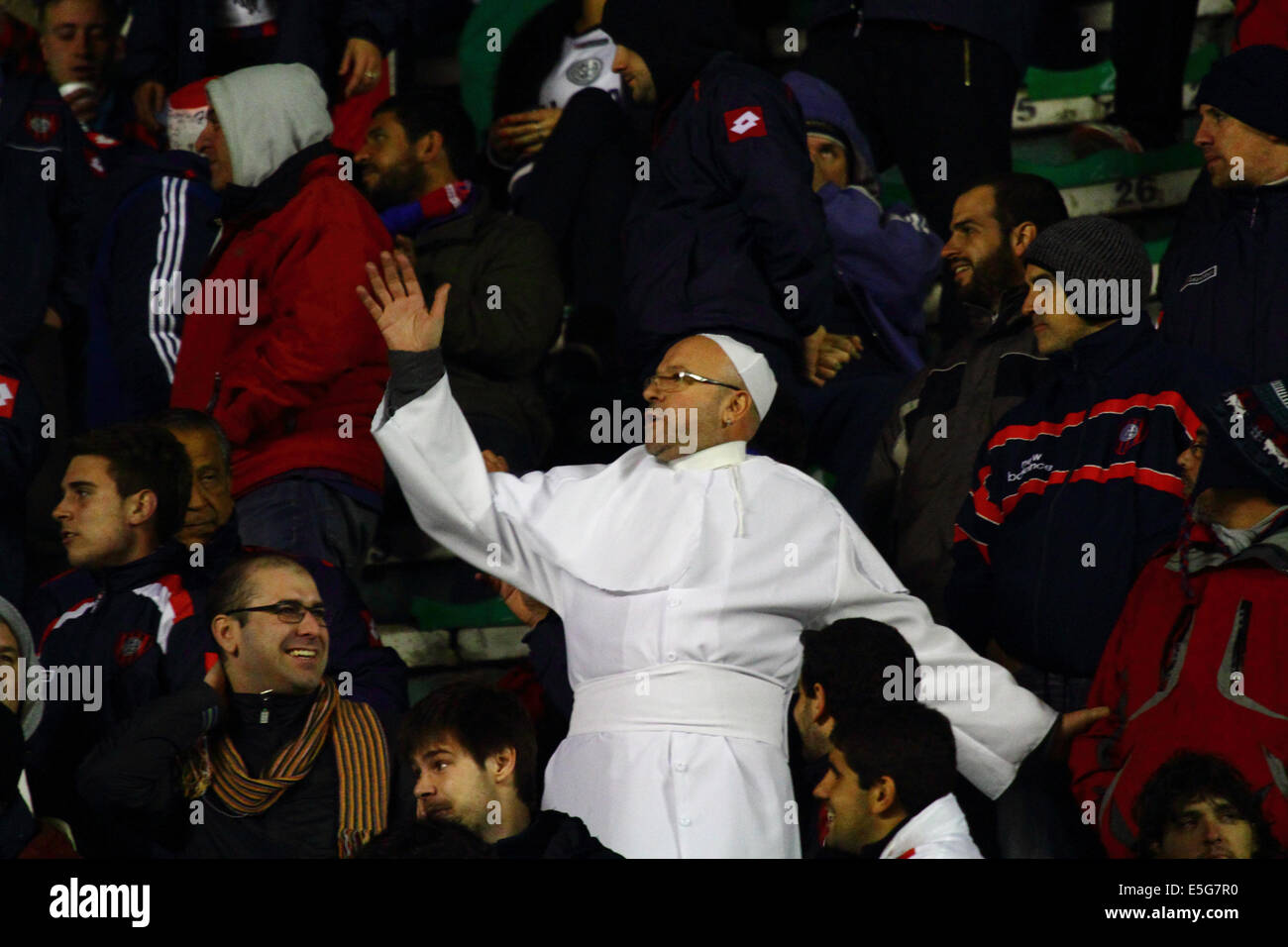 La Paz, Bolivia. 30th July, 2014.  A San Lorenzo fan dressed as Pope Francis watches his team during a second leg of a Copa Libertadores 2014 semi final match at the Hernando Siles Stadium. San Lorenzo won the first leg 5-0; Bolívar the return leg 1-0. Pope Francis is well known for his interest in football / soccer and support for the San Lorenzo team. Credit:  James Brunker / Alamy Live News Stock Photo
