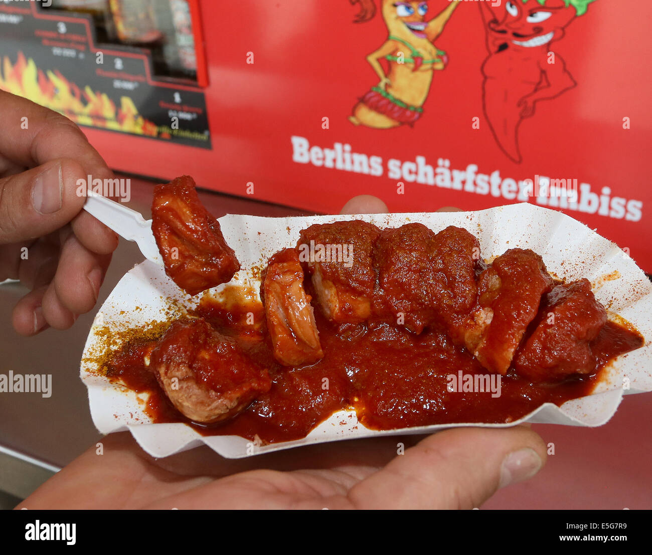 Berlin, Germany. 07th July, 2014. A hot currywurst is pictured at the diner 'Curry & Chily' in Wedding in Berlin, Germany, 07 July 2014. The diner offers curry sausages in varying degrees of spiciness. Customers who eat a meal with the spiciness degree ten can become a member in the curry club and have their portrait shown at the diner. Photo: Stephanie Pilick/dpa/Alamy Live News Stock Photo