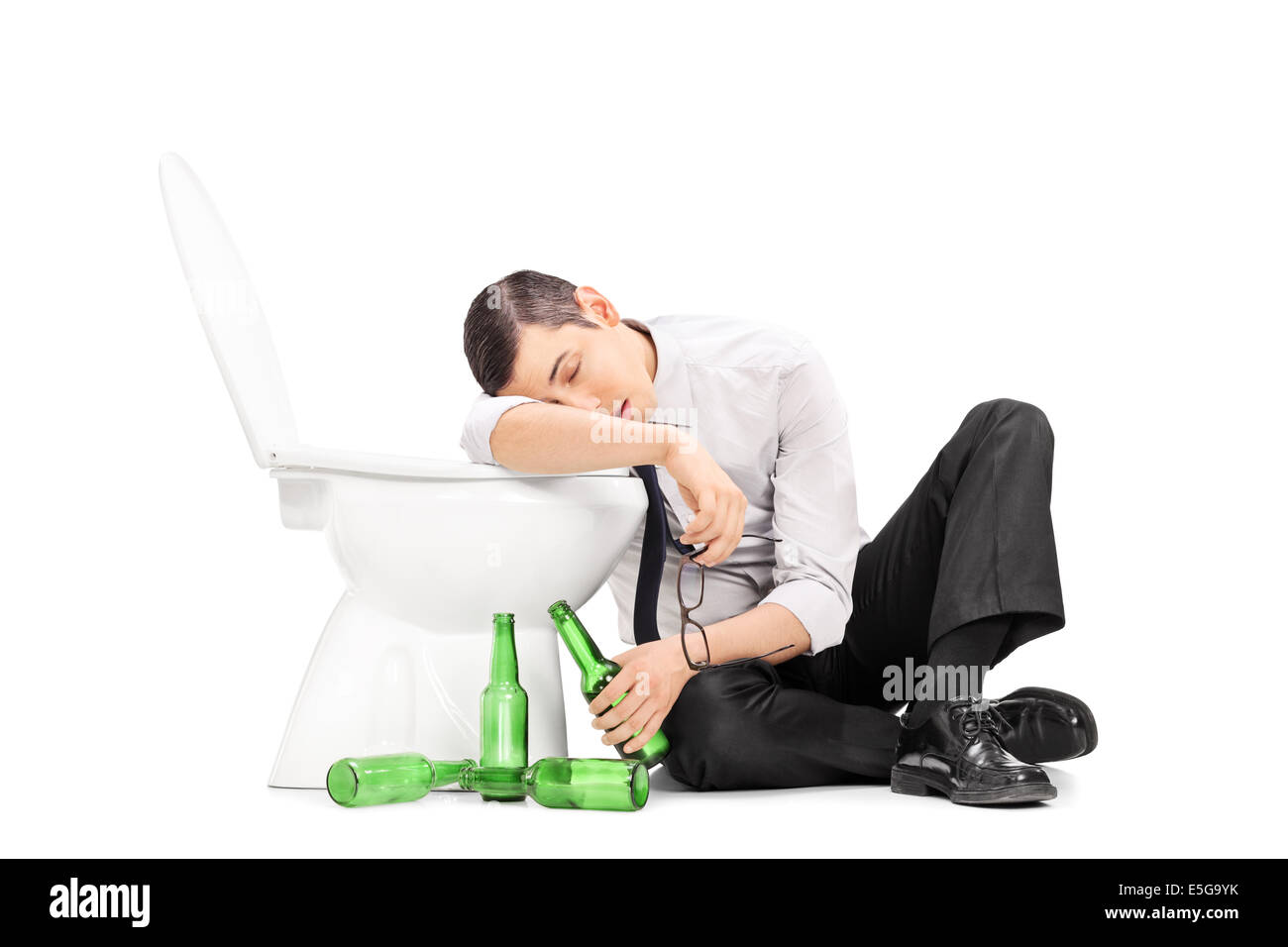 Male alcoholic sleeping on a toilet Stock Photo