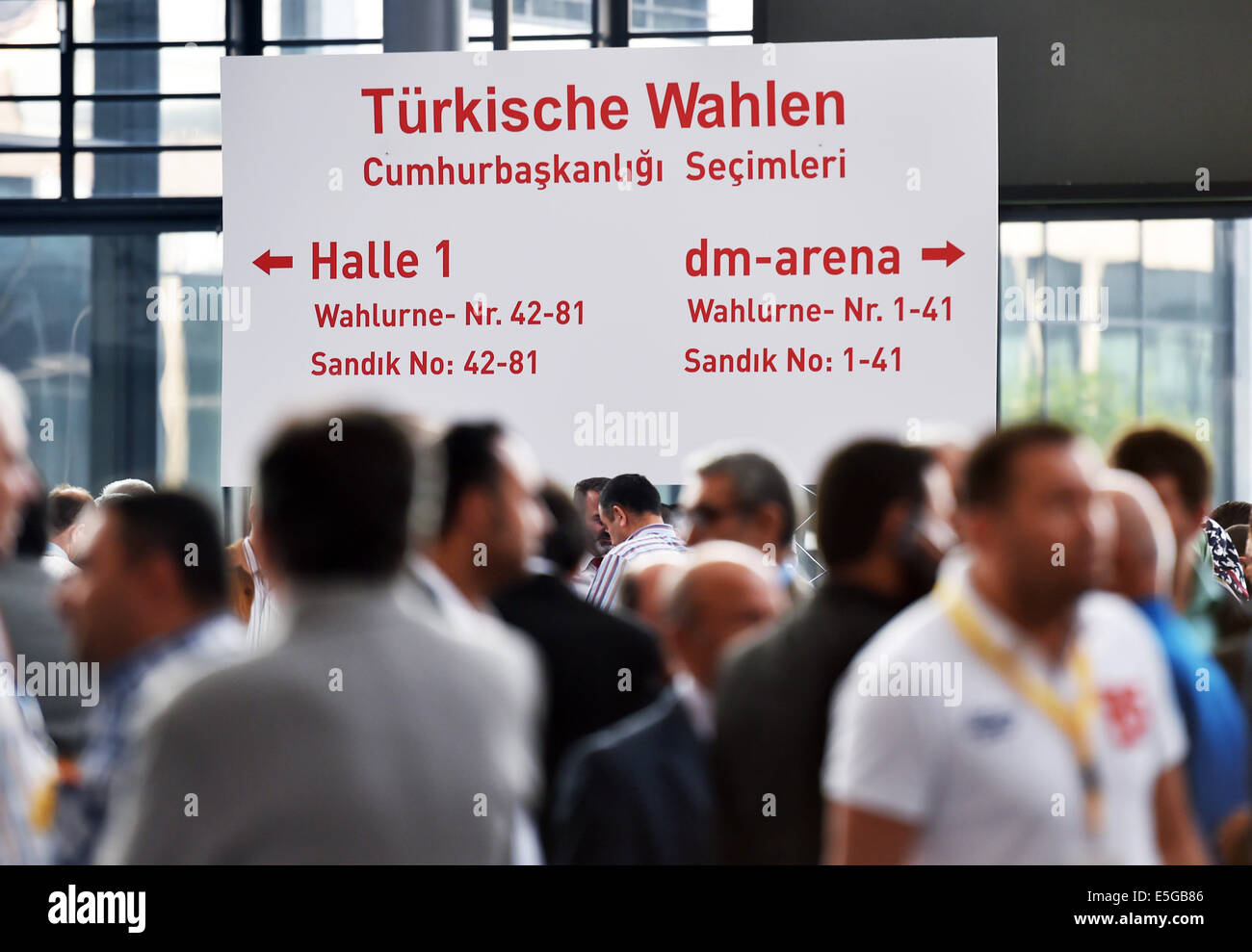 People stand in front of a sign which reads 'Turkish elections' at the exhibition center in Karlsruhe, Germany, 31 July 2014. The voting for the Turkish presidential election started on 31 July for Turkish citizens living abroad. The presidential election in Turkey has been scheduled for 10 August 2014. Photo: ULI DECK/dpa Stock Photo