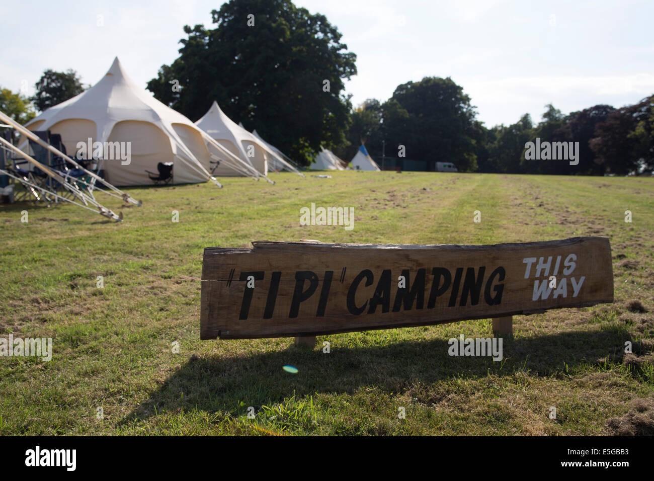 Tipi camping sign in campsite. Teepees. Glamping at a family music festival. Stock Photo