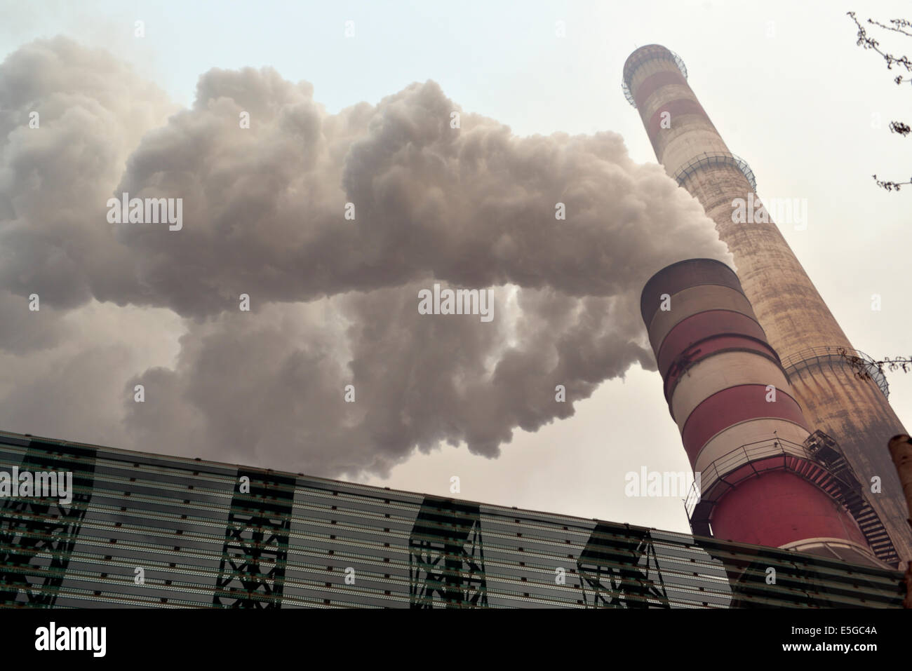 Black smoke emitted from the chimney of a private iron and steel Stock