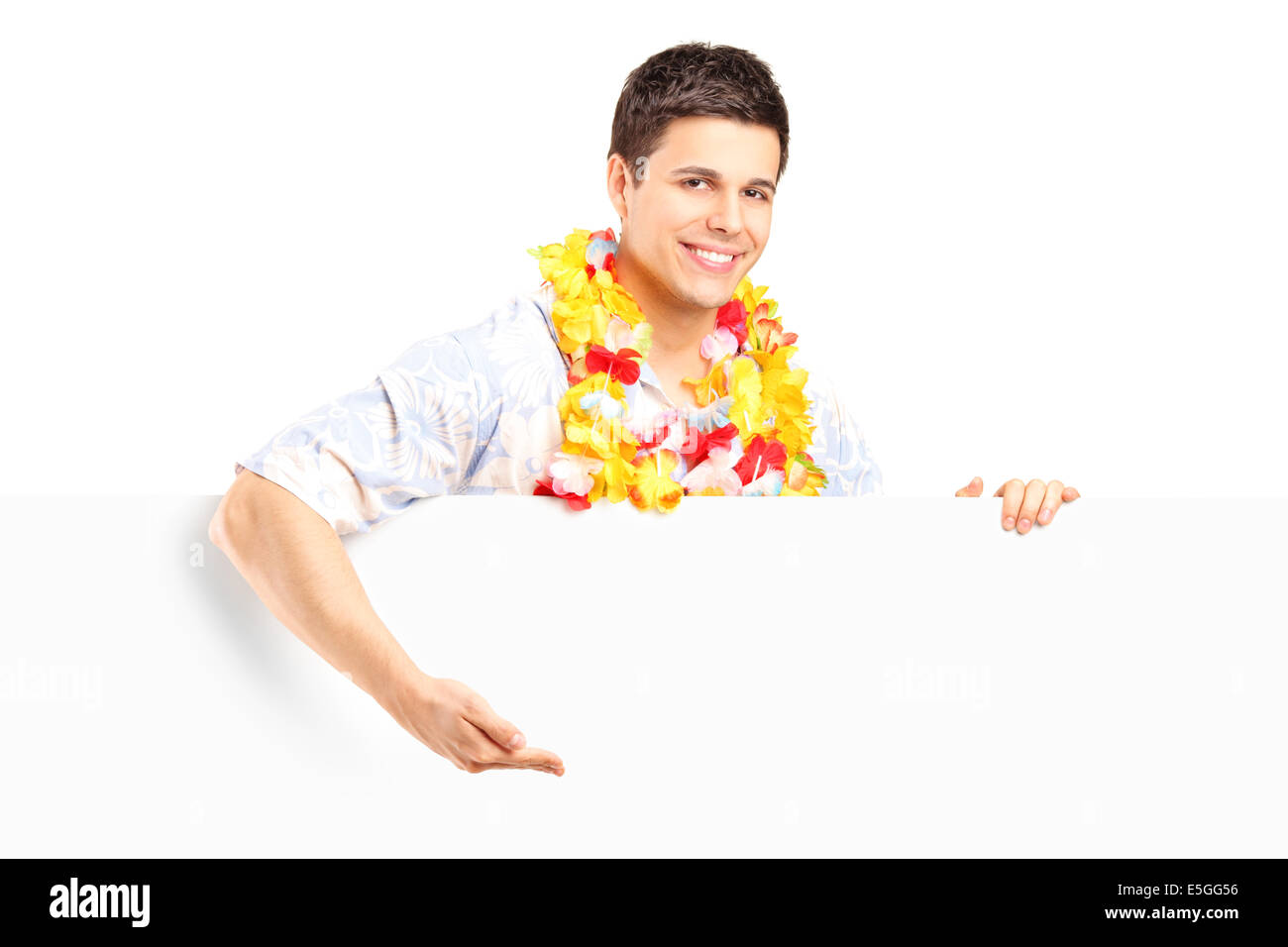 Young man with lei around his neck behind a panel Stock Photo