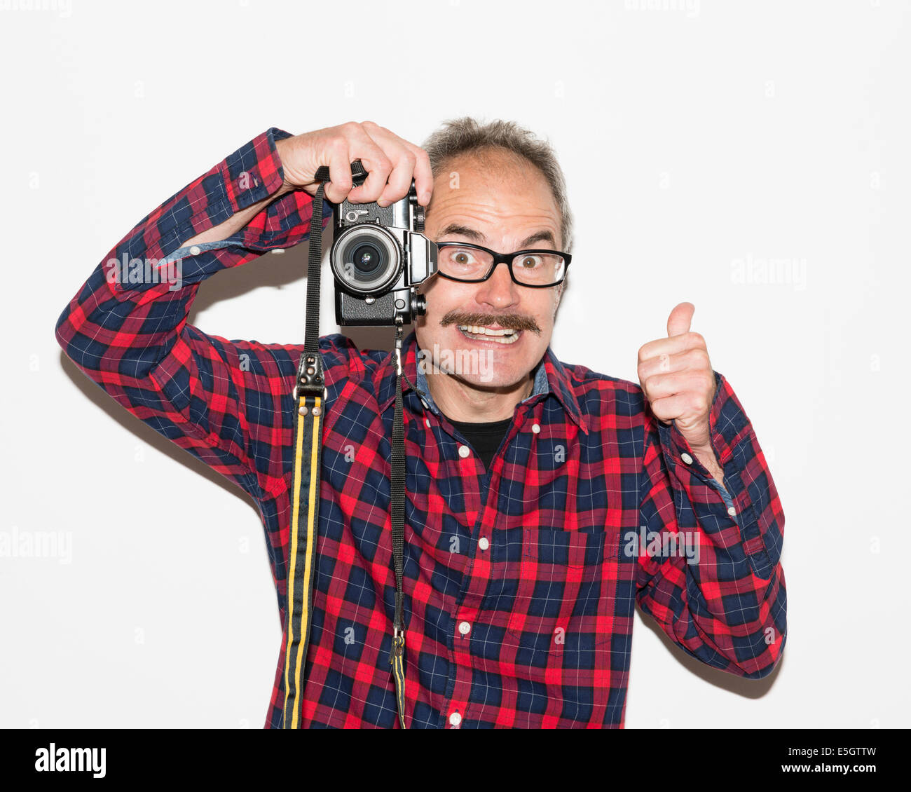 Fashion photographer guy with moustache, glasses, plaid shirt giving