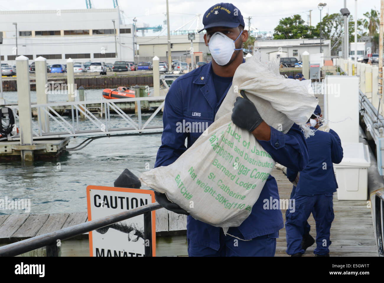 U.S. Coast Guard Petty Officer 3rd Class Roger Lewis, assigned to Coast Guard Station Miami Beach, Fla., helps unload a shipmen Stock Photo