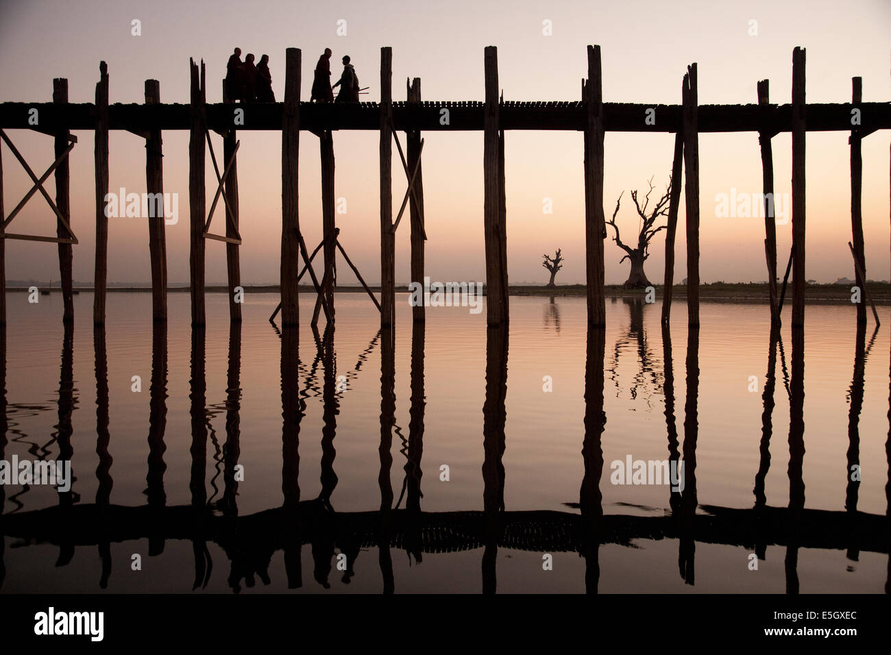 Monks crossing Taungthaman lake on the U Bein teak bridge, Amarapura ...