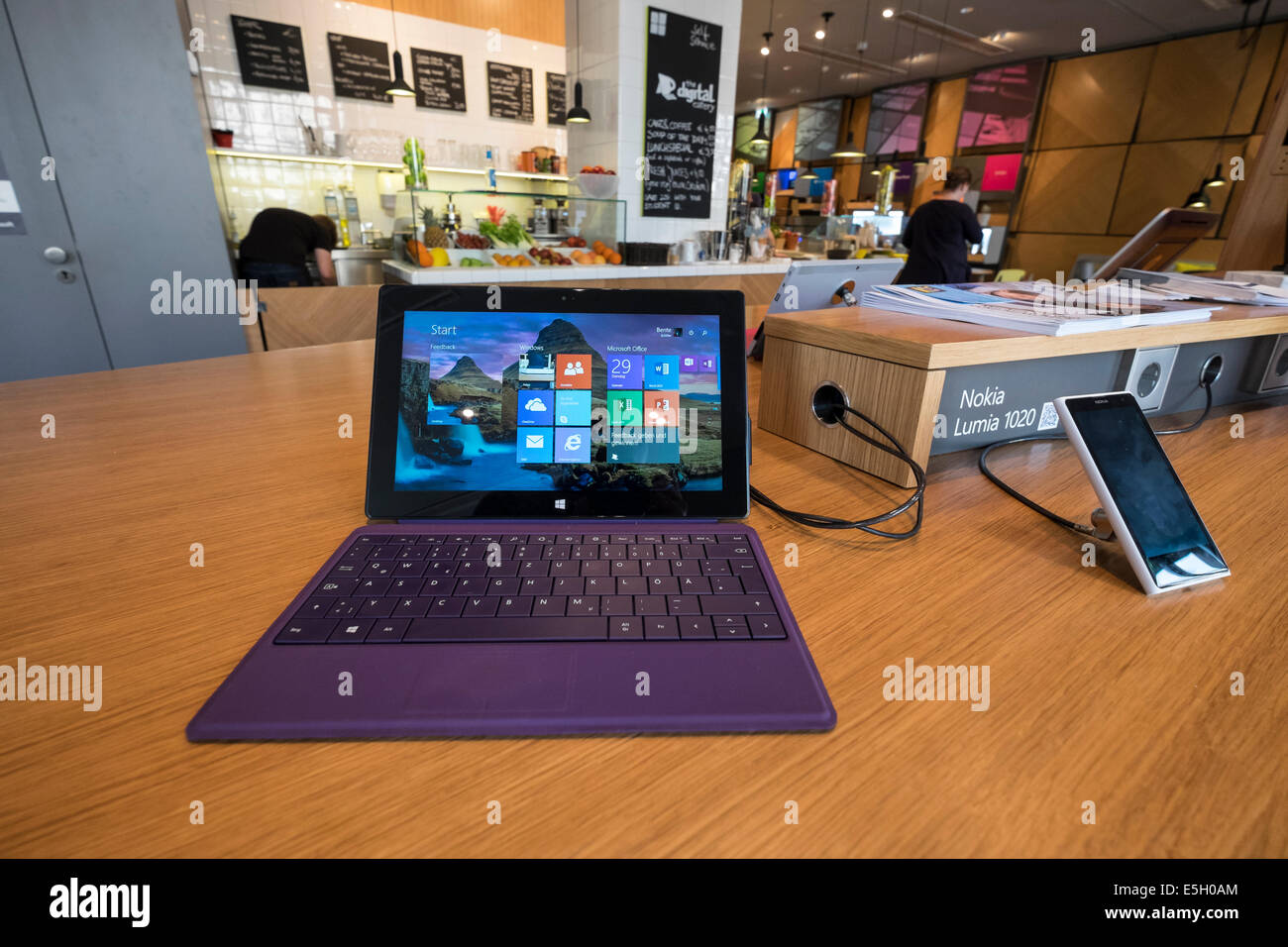 Touchscreen tablet computers and smart phones  at new Microsoft Digital Eatery cafe on Unter den Linden in Berlin Germany Stock Photo