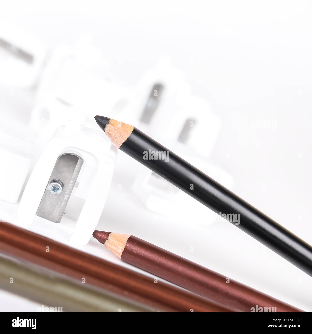 Sharpeners and make-up pencils on white background Stock Photo