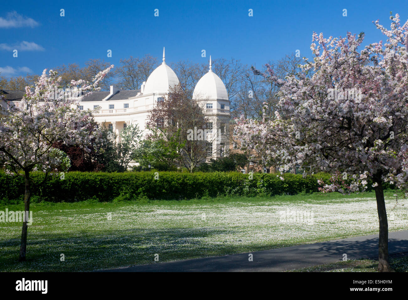 The Regent's Park in spring with blossom on trees and John Nash's Sussex Place terrace on the Outer Circle London England UK Stock Photo