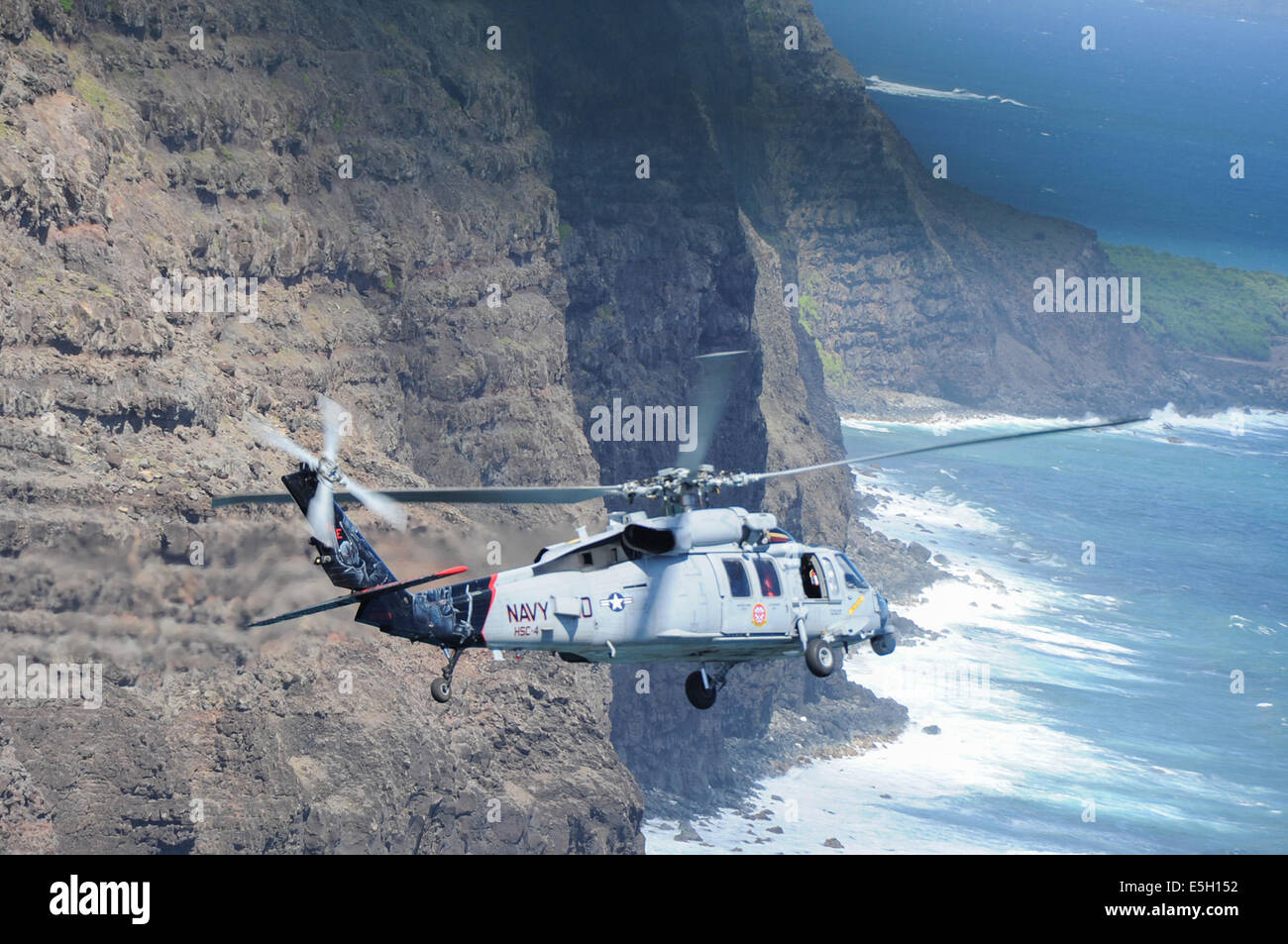 A U.S. Navy MH-60S Seahawk helicopter attached to Helicopter Combat Support Squadron (HSC) 4 participates in a helicopter train Stock Photo