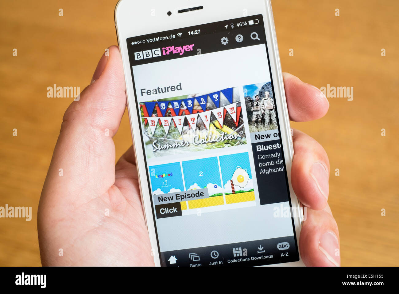 Using BBC iPlayer television catchup app to watch television programmes on iPhone smart phone Stock Photo