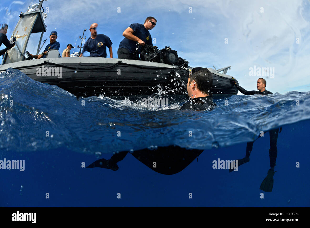 U.S. Navy divers with Mobile Diving and Salvage Unit 1 assist Coast