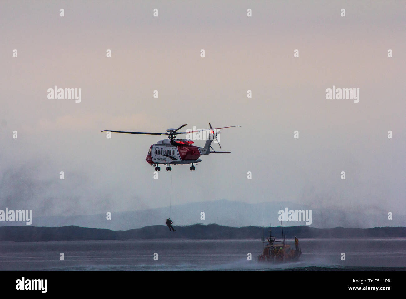 Coast guard rescue boat and helicopter Stock Photo