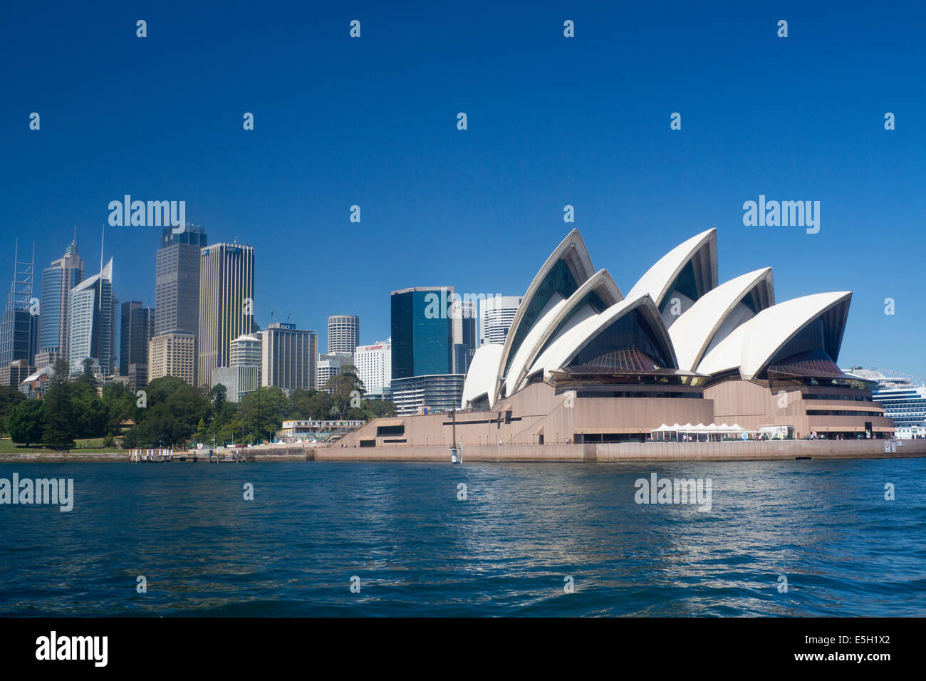 Sydney Opera House and skyscrapers of CBD Central Business District seen from ferry on harbour Sydney New South Wales NSW Austra Stock Photo