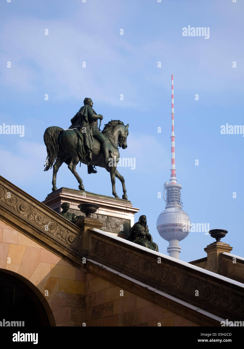 equestrian statue of Frederick William IV on the entrance to Old National Gallery and Berlin TV tower behind Stock Photo