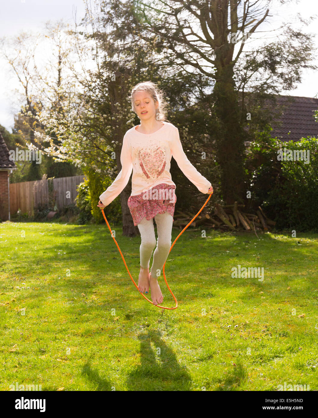 young girl using skipping rope Stock Photo Alamy
