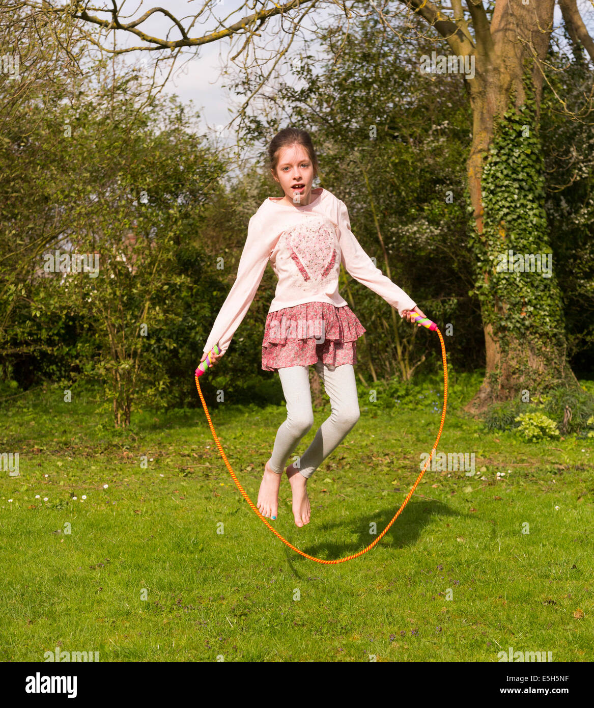 young girl using skipping rope Stock Photo