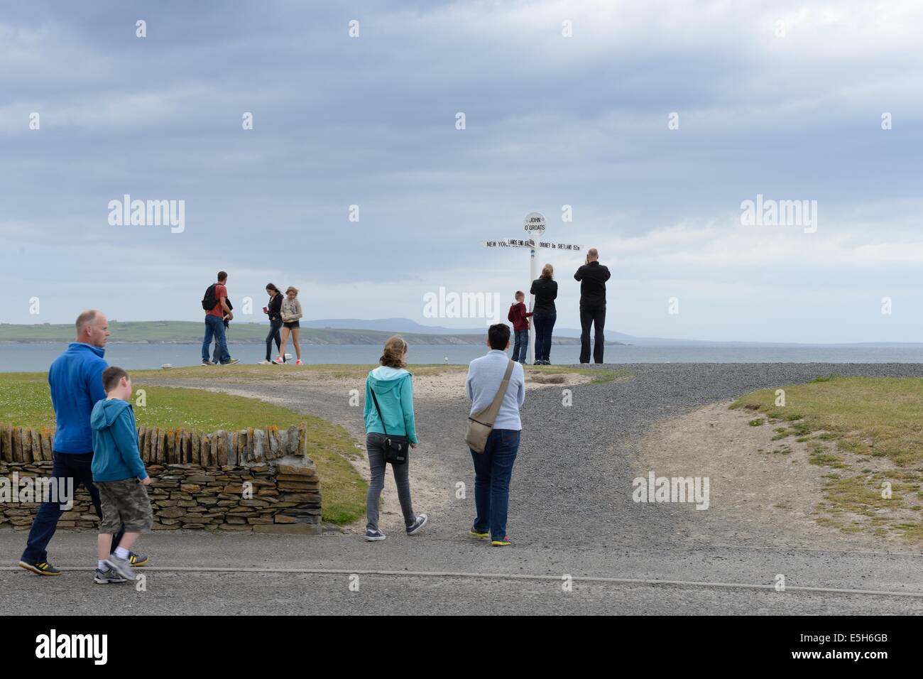 People gathering at John O' Groats signpost which is 876 miles from Lands End in the southernmost point in England Stock Photo