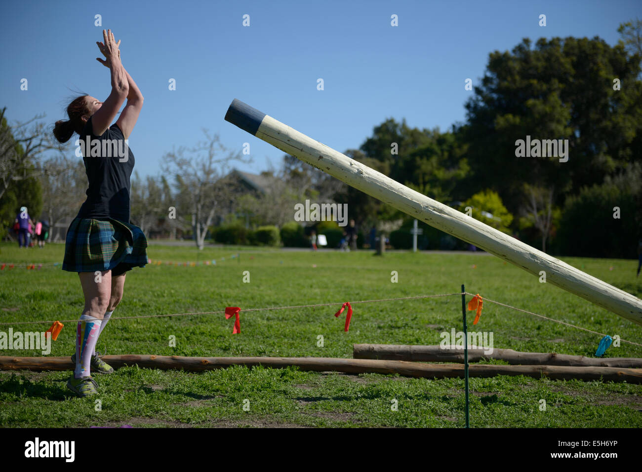 woman tosses caber highland games california Stock Photo