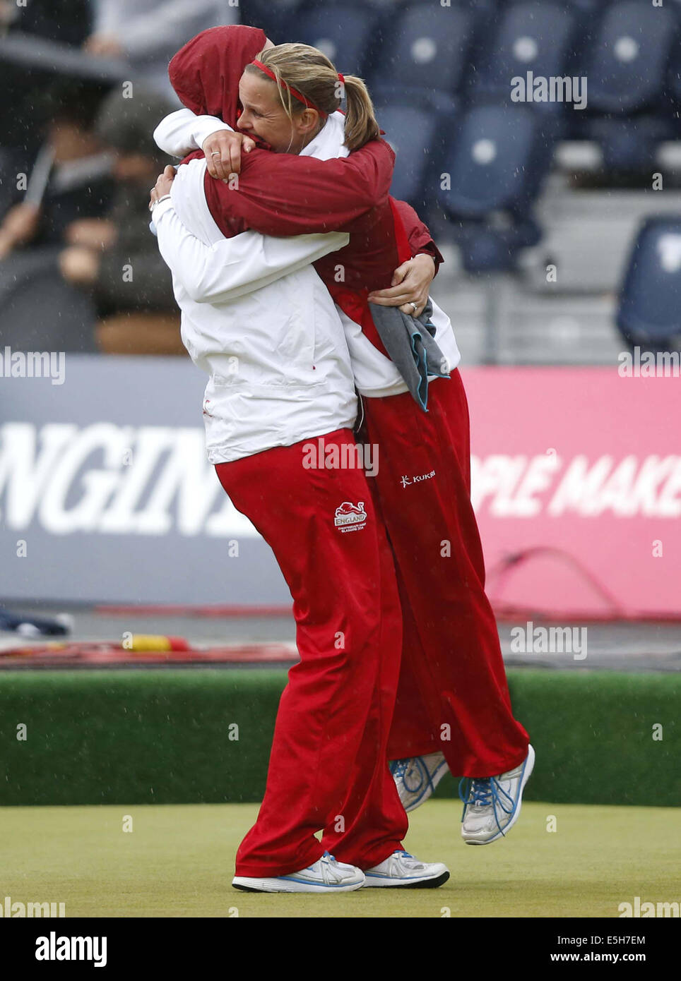 Glasgow, Scotland. 31st July, 2014. Ellen Falkner (R) of England celebrates with her teammate Sian Gordon after the women's triples gold medal match of Lawn Bowls between England and Australia on day 8 of the Glasgow 2014 Commonwealth Games at Kelvingrove Lawn Bowls Centre in Glasgow, Scotland, on July 31, 2014. England claimed the title with 22-4. Credit:  Wang Lili/Xinhua/Alamy Live News Stock Photo