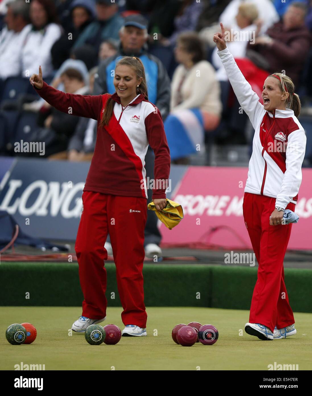 Glasgow, Scotland. 31st July, 2014. Ellen Falkner (R) of England celebrates with her teammate Sophie Tolchard during the women's triples gold medal match of Lawn Bowls between England and Australia on day 8 of the Glasgow 2014 Commonwealth Games at Kelvingrove Lawn Bowls Centre in Glasgow, Scotland, on July 31, 2014. England claimed the title with 22-4. Credit:  Wang Lili/Xinhua/Alamy Live News Stock Photo