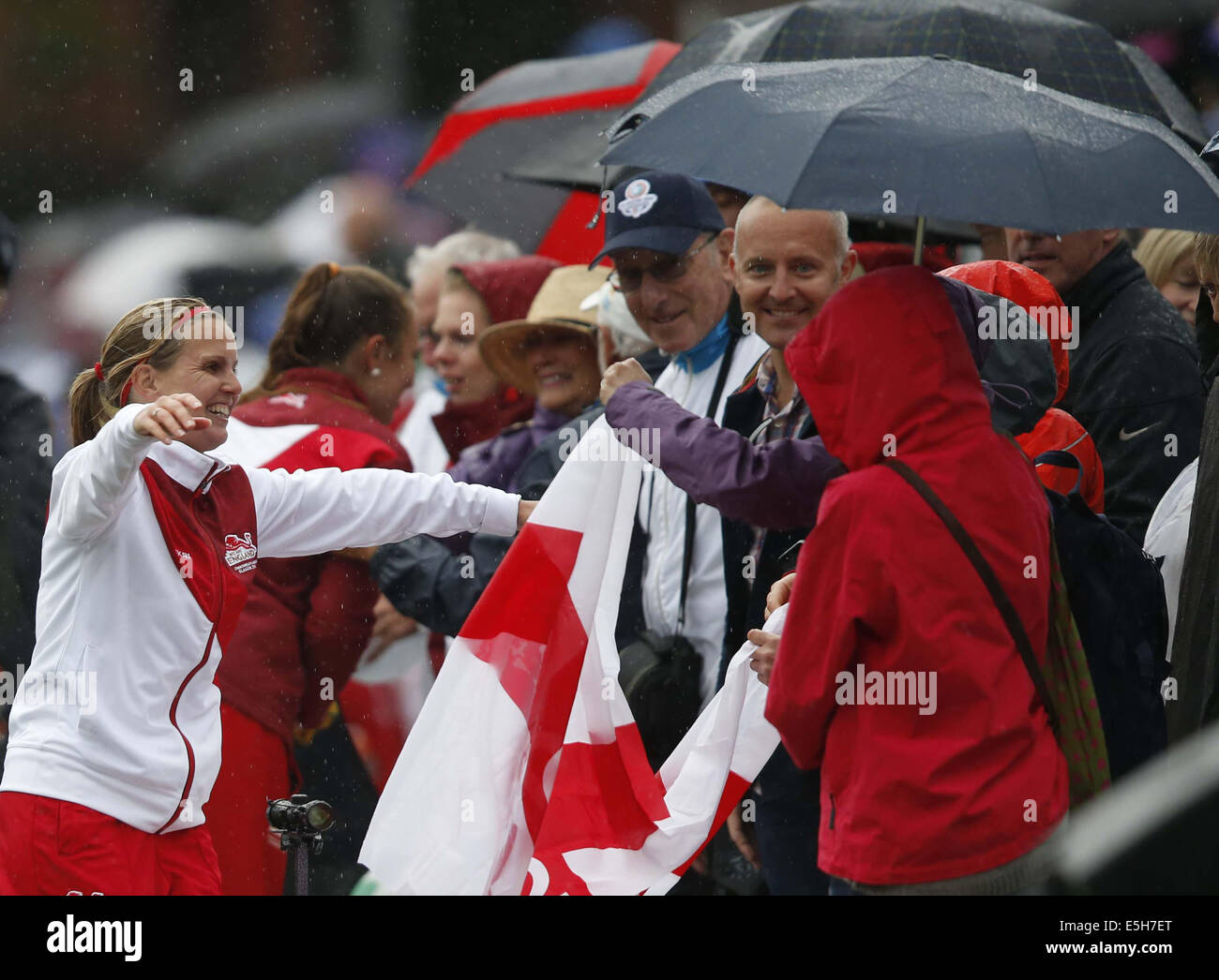 Glasgow, Scotland. 31st July, 2014. Ellen Falkner (L) of England celebrates with friends after the women's triples gold medal match of Lawn Bowls between England and Australia on day 8 of the Glasgow 2014 Commonwealth Games at Kelvingrove Lawn Bowls Centre in Glasgow, Scotland, on July 31, 2014. England claimed the title with 22-4. Credit:  Wang Lili/Xinhua/Alamy Live News Stock Photo
