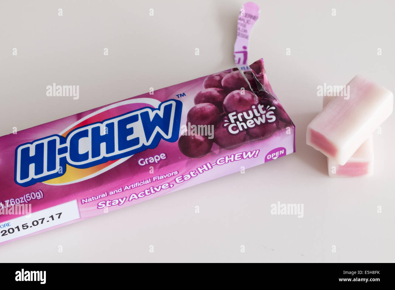 A stick of grape Hi-Chew chewy Japanese candy, manufactured by Morinaga & Company. Stock Photo
