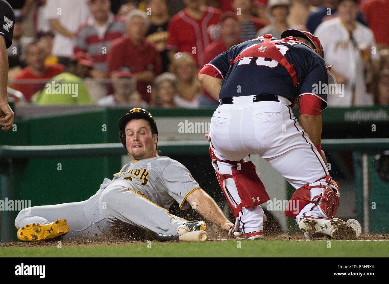 Washington DC, USA. 15th Aug, 2014. Pittsburgh Pirates right fielder Travis Snider (23) is safe at home plate as Washington Nationals catcher Wilson Ramos (40) can handle the throw during the fourth inning of their game at Nationals Park in Washington, D.C, Friday, August 15, 2014. Credit:  Harry Walker/Alamy Live News Stock Photo