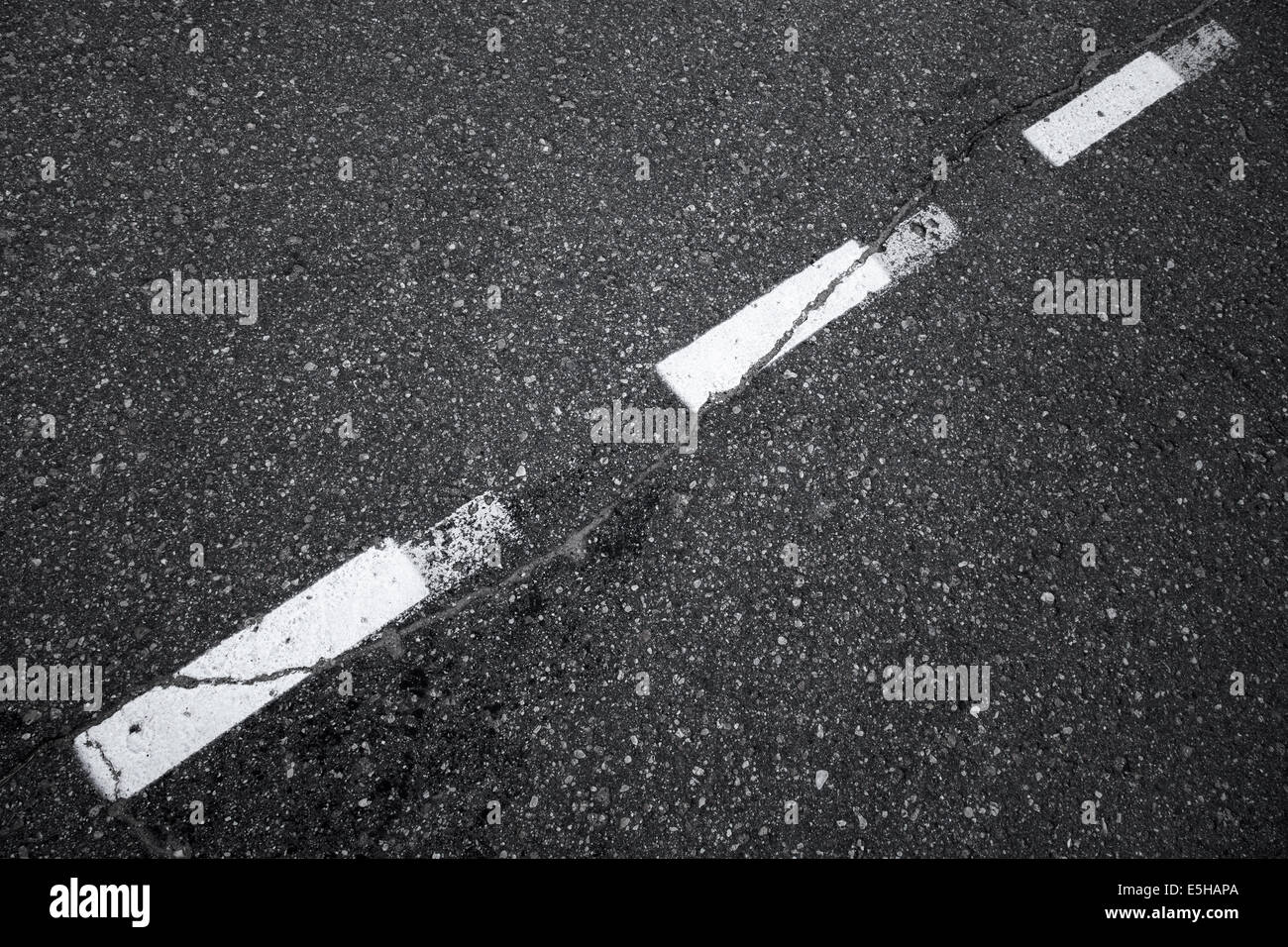 Black asphalt road background with striped dividing marking line Stock Photo