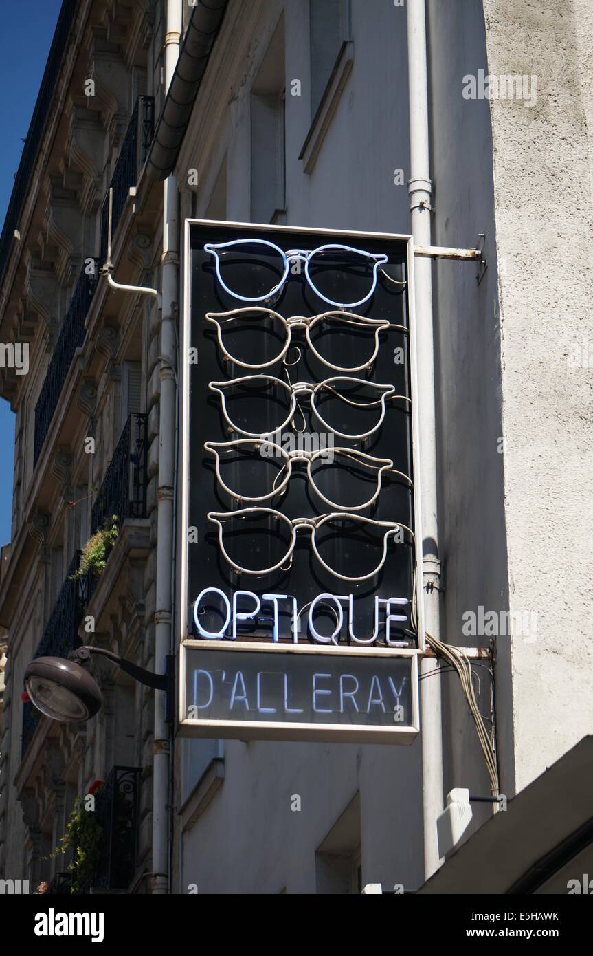 The modern neon design spectacles sign outside an optician's (optique) premises in Paris Stock Photo