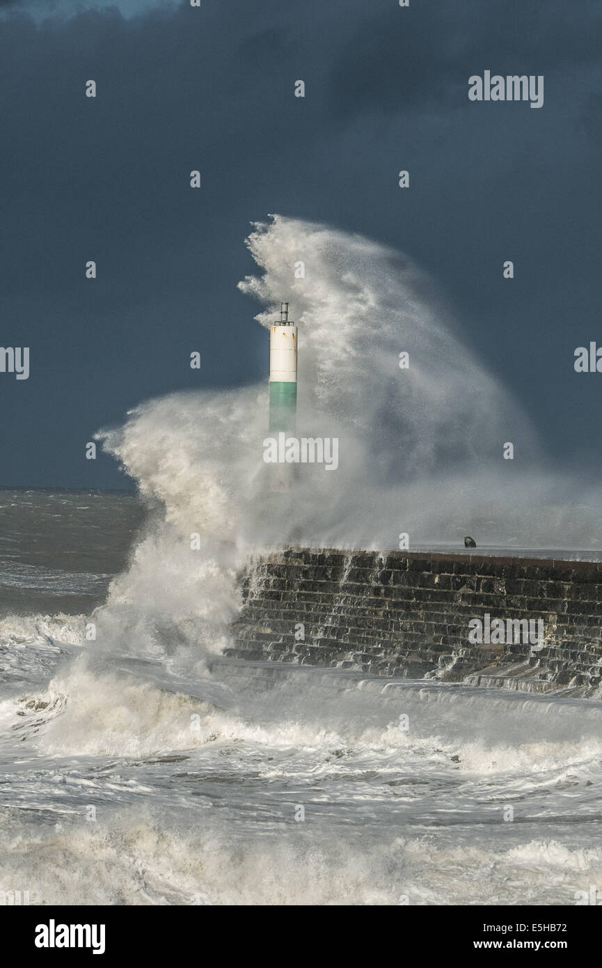 Aberystwyth, Wales, UK. 24 December 2013.  17-BEFORE: DURING THE STORMS. After a brief lull, gale force winds return to bring boiling seas and monstrous waves to batter the harbour wall at Aberystwyth on the west Wales coast. The local RNLI flood response team are on standby by as amber weather warnings are issued for much of south and west Wales. Credit:  keith morris/Alamy Live News Stock Photo