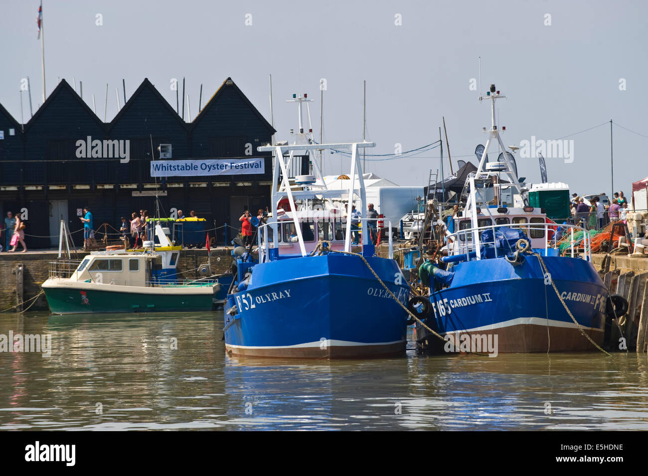 Fishing boats moored in harbour during Whitstable Oyster Festival at