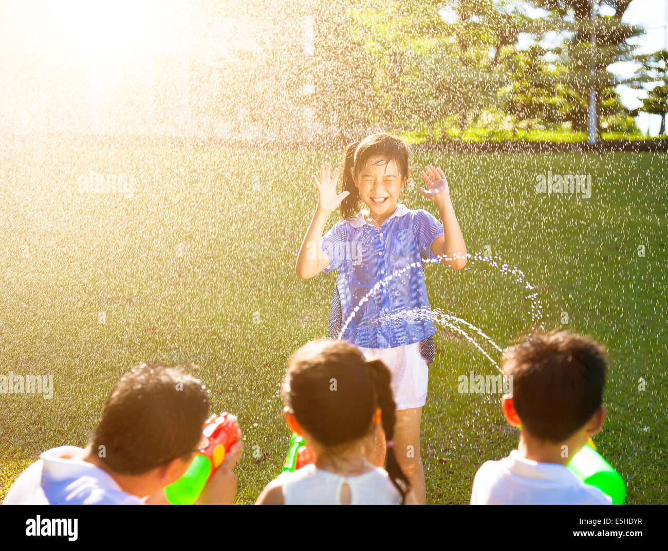 little girl Punishment for water gun spray to wet body Stock Photo