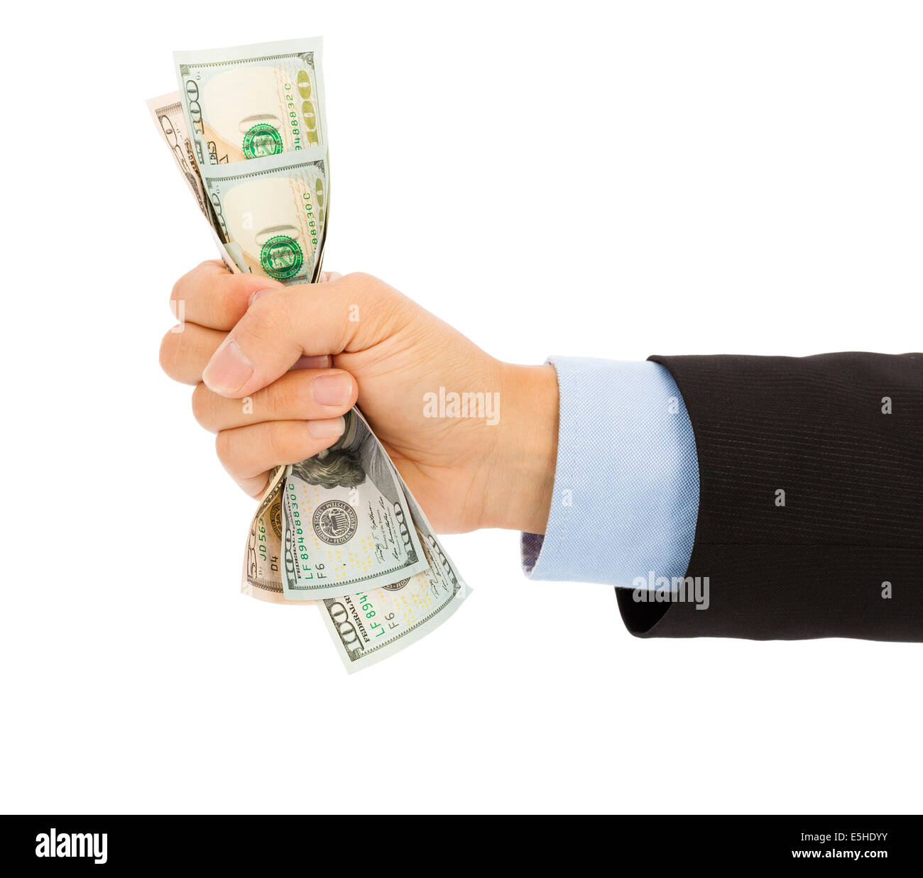businessman's hand grasping a handful of dollars Stock Photo