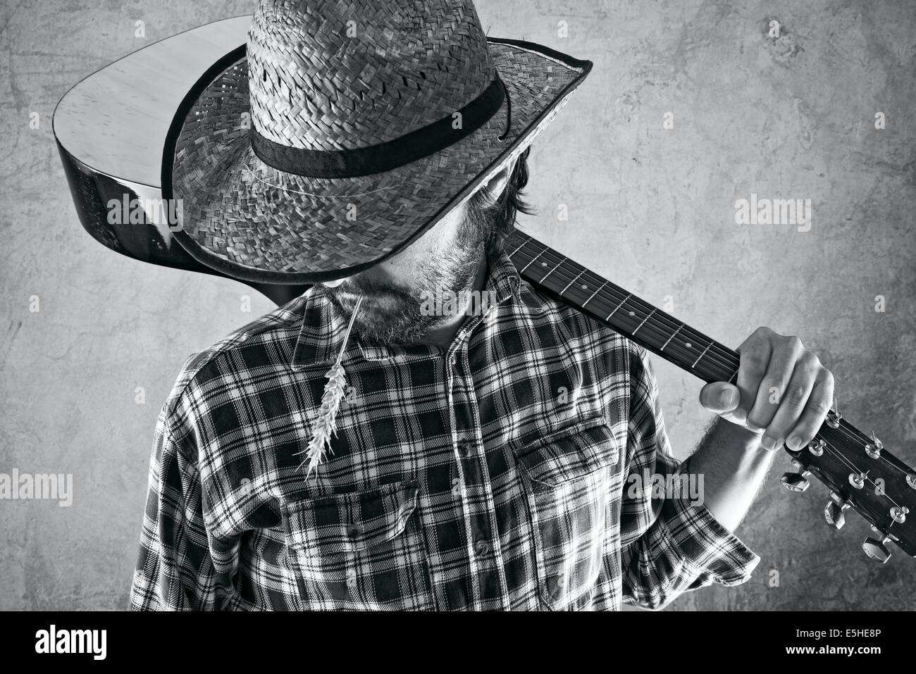 Western country cowboy musician with guitar, black and white portrait. Stock Photo