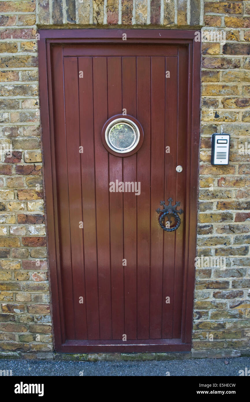 Wooden Brown Front Door With Intercom Of Renovated House In Stock