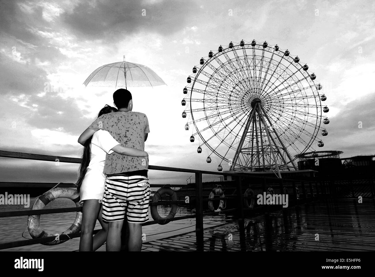 Qingdao, Shandong, CHN. 30th July, 2014. Qingdao, CHINA - JUL 30 2014ï¼šThe ''Eye of Qin Island'' ferris wheel.(photo was converted into black and white.)The ''Eye of Qin Island'' ferris wheel is the only one in North China with the colorful and gorgeous light show, which has one hundred kind of type. It is 68 meters high, the body is a joint of radial spokes, and has 36 all perspective sea-view compartments © SIPA Asia/ZUMA Wire/Alamy Live News Stock Photo