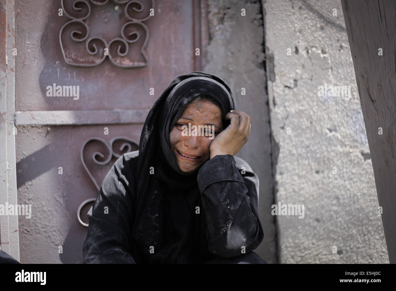 Gaza. 1st Aug, 2014. Palestinian woman cries looking her ruined home in ...