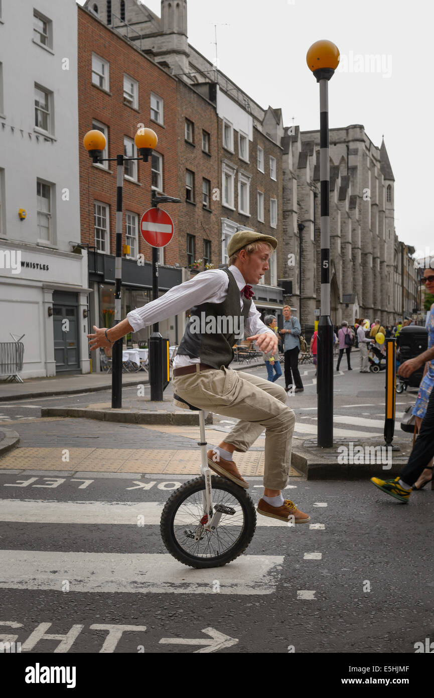 A street performer on a unicycle entertaining the public at Marylebone