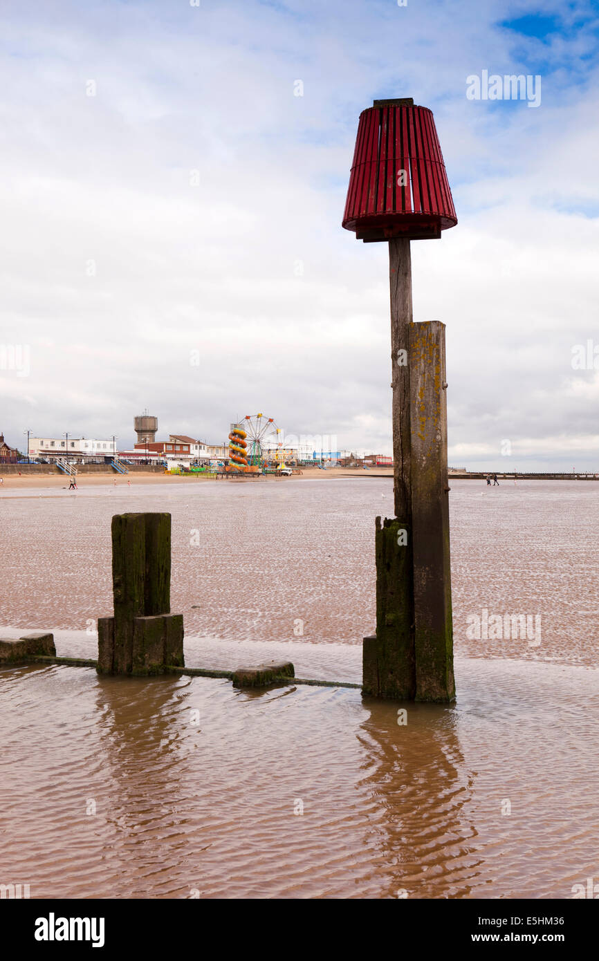 UK, England, Lincolnshire, Cleethorpes, seafront attractions from breakwater groyne beside pier on Humber Estuary Stock Photo