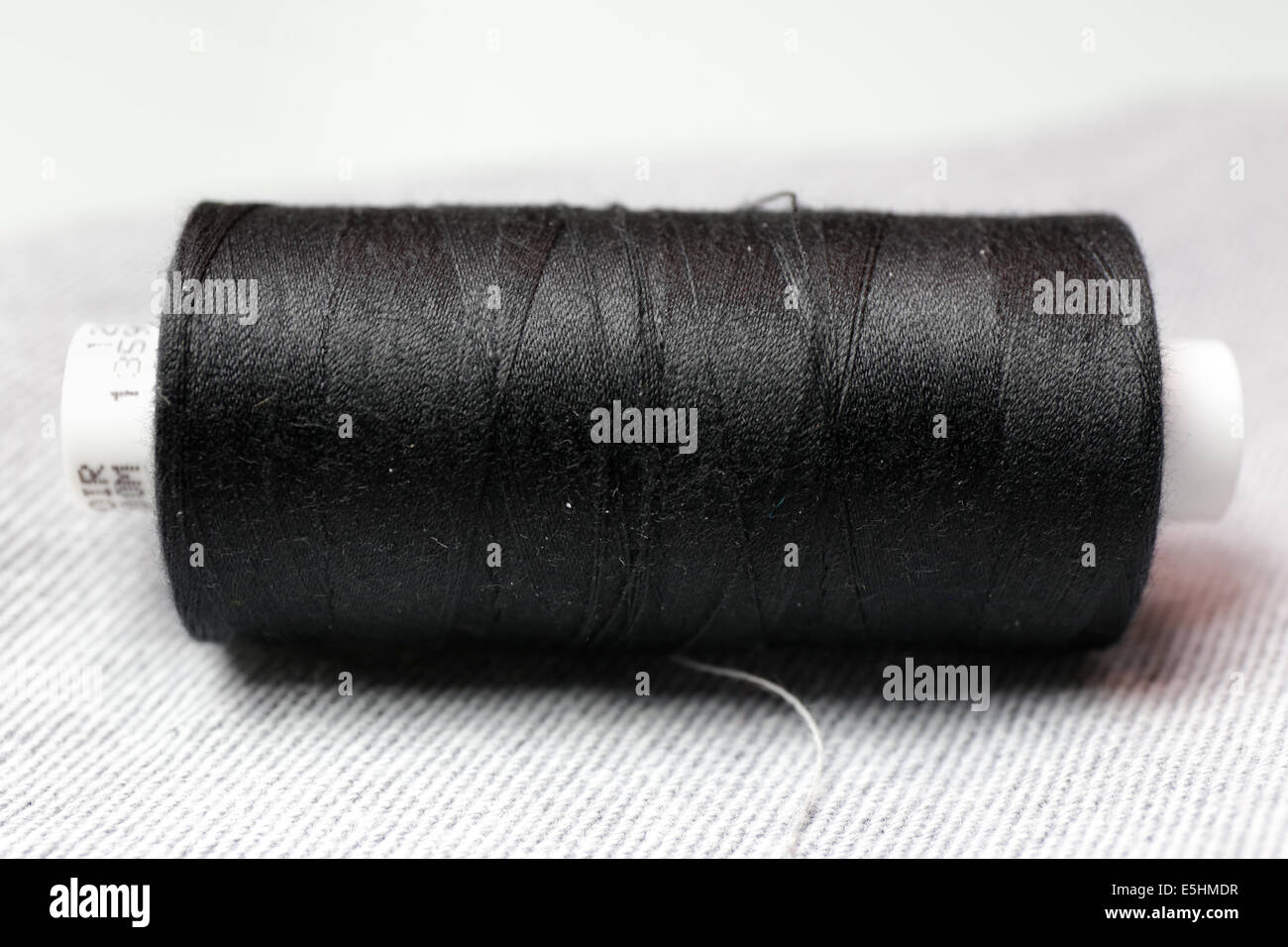 Roll of black thread Stock Photo - Alamy