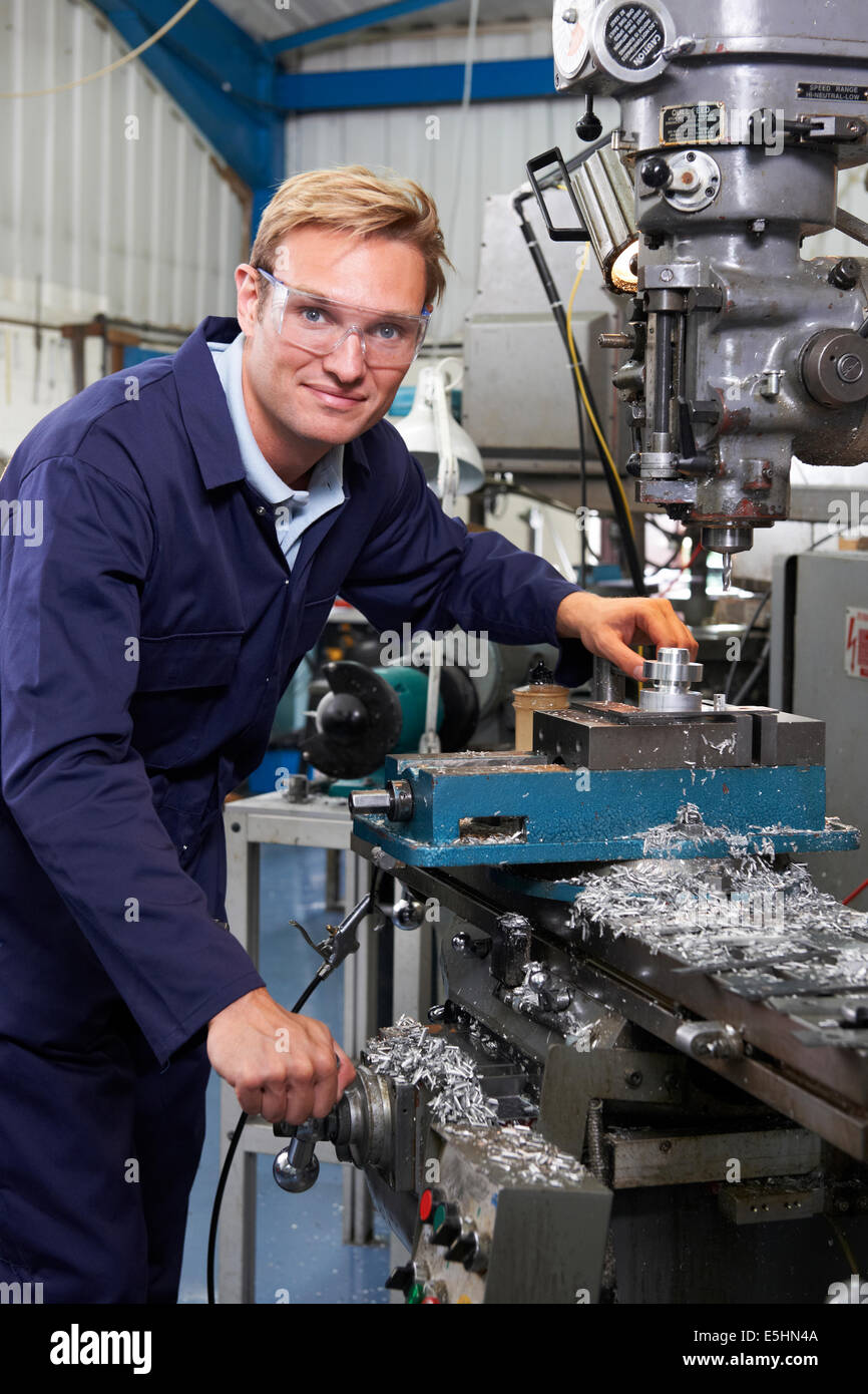 Portrait Of Engineer Using Drill In Factory Stock Photo