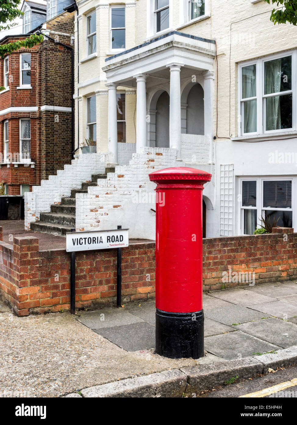Red Post box in a suburban street, Twickenham, London, UK Stock Photo