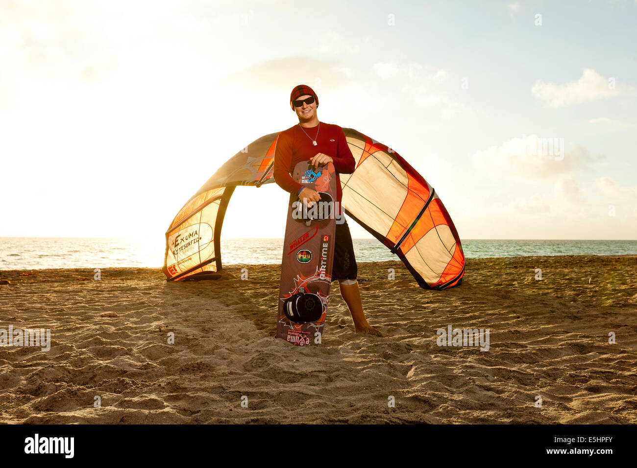 Kiteboarder holding wakeboard Stock Photo