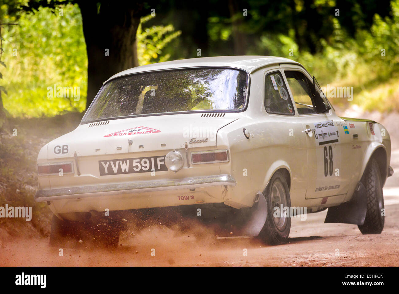1968 Ford Escort Twin Cam with driver David Watkins on the forest stage at the 2014 Goodwood Festival of Speed, Sussex, UK. Stock Photo