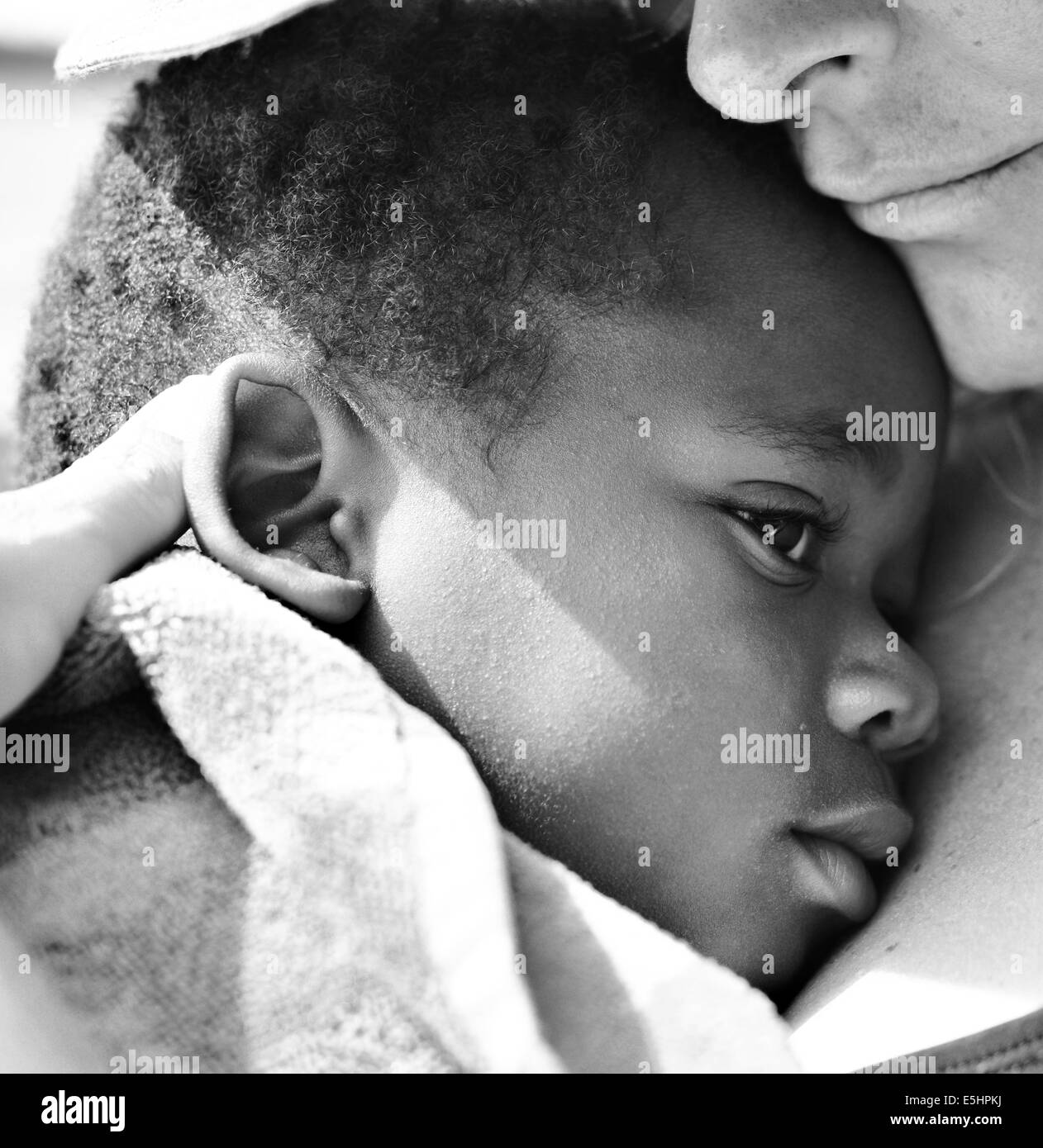 Toddler/baby in BW laying with mom wrapped in a towel Stock Photo